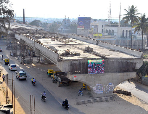 Hennur road flyover began in 2010, but 41 private property owners have refused to give up land. DH photo