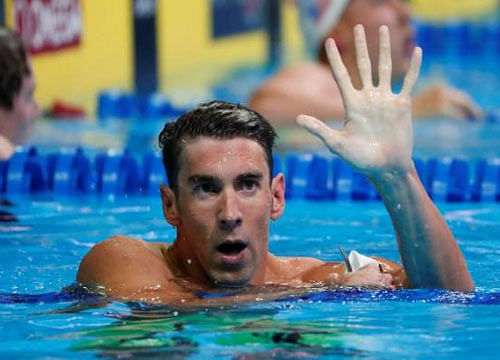 Michael Phelps holds up five fingers during the finals for the men's 200 meter butterfly in the U.S. Olympic swimming team trials at CenturyLink Center. Mandatory Credit: Erich Schlegel-USA TODAY Sports /Reuters