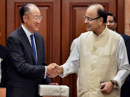 Union Finance Minister Arun Jaitley exchange gifts with Jim Yong Kim, President, World Bank after a meeting in New Delhi on Thursday. The World Bank Group signed an agreement with the International Solar Alliance (ISA), consisting of 121 countries led by India. PTI Photo