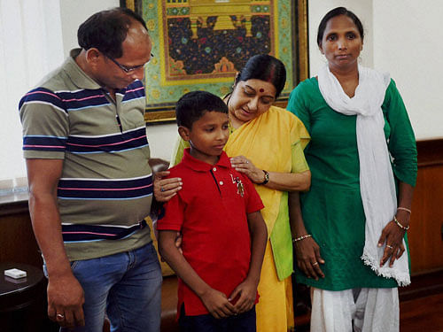 External Affairs Minister Sushma Swaraj interacts with Twelve-year-old Indian boy Sonu, who was kidnapped from Delhi six years ago and taken to Bangladesh, after has been brought back in New Delhi on Thursday. Sonu's parents are also seen. PTI Photo