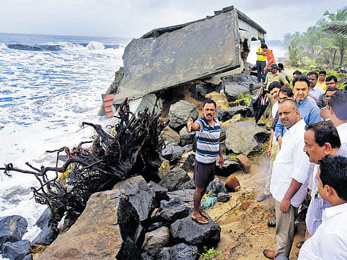 Food and Civil Supplies Minister U T Khader inspects the damage caused by sea erosion at Ucchila near Ullal on Thursday. Deputy Commissioner A B Ibrahim and others look on. DH PHOTO