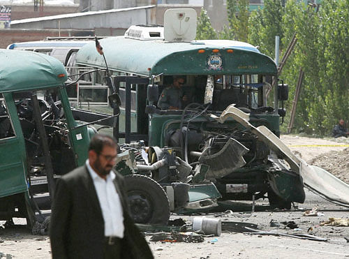 Afghan security forces inspect the site of a suicide attack on the outskirts of Kabul, Afghanistan, Thursday, June 30, 2016. A twin suicide attack on a convoy of buses carrying police cadets killed 37 people and wounded 40 others on Thursday, an Afghan official said. AP/PTI Photo