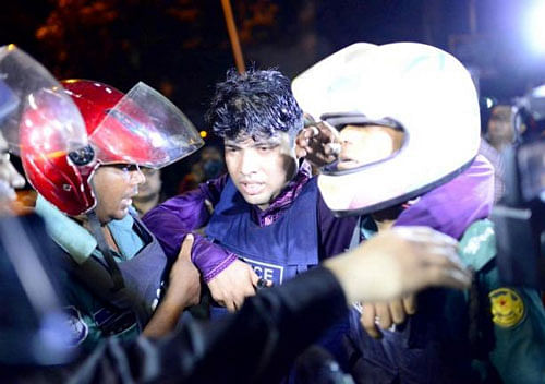 An injured member of the police personnel is carried away by his colleagues, after gunmen stormed a restaurant popular with expatriates in the diplomatic quarter of the Bangladeshi capital, in Dhaka July 1, 2016. Courtesy of Dhaka Tribune/Mahmud Hossain Opu via/Reuters