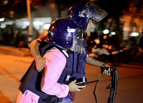 An unidentified security personnel is taken for medical attention after a group of gunmen attacked a restaurant popular with foreigners in a diplomatic zone of the Bangladeshi capital Dhaka, Bangladesh. AP/PTI