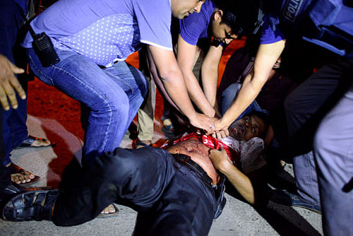 People try to help an injured person, after gunmen stormed the Holey Artisan restaurant and took hostages, in the Gulshan area of Dhaka, Bangladesh. Reuters photo