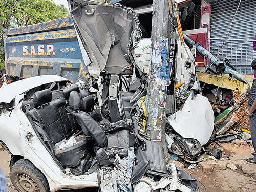 The mangled remains of the tipper lorry and the car that were involved in collision at Shivananda Circle in the early hours of Saturday. dh photo