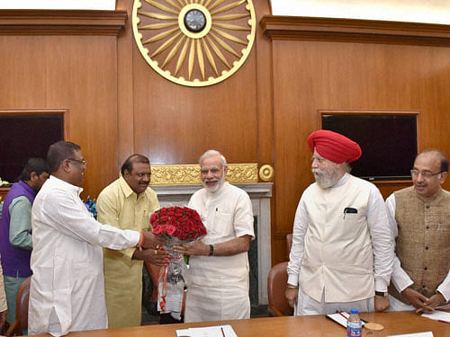 Prime Minister Narendra Modi is greeted by the newly inducted ministers at a meeting in New Delhi on Tuesday. PTI Photo