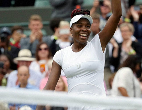 Venus Williams of the U.S celebrates after beating Carla Suarez Navarro of Spain in their women's singles match on day eight of the Wimbledon Tennis Championships in London. AP/PTI