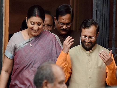 HRD Minister Smriti Irani with new Cabinet minister Prakash Javadekar after a Cabinet meeting at South Block in New Delhi on Tuesday. PTI Photo