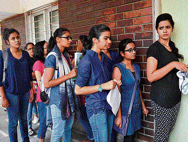 Students waiting in a queue to complete their admission process at a college in New Delhi on Tuesday.