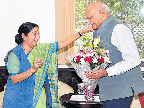 M J Akbar greets External Affairs Minister Sushma Swaraj at her residence before taking charge as a Minister of State for External Affairs in New Delhi on Wednesday. PTI
