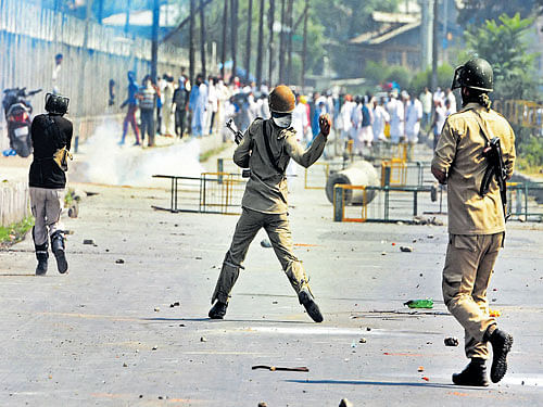 Storm after calm: Police in action against protesters during a clash after Eid prayers in Srinagar on Wednesday.  PTI