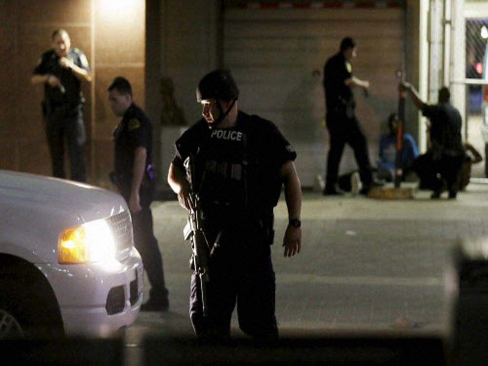 Dallas police detain a driver after several police officers were shot in downtown Dallas. AP/PTI photo
