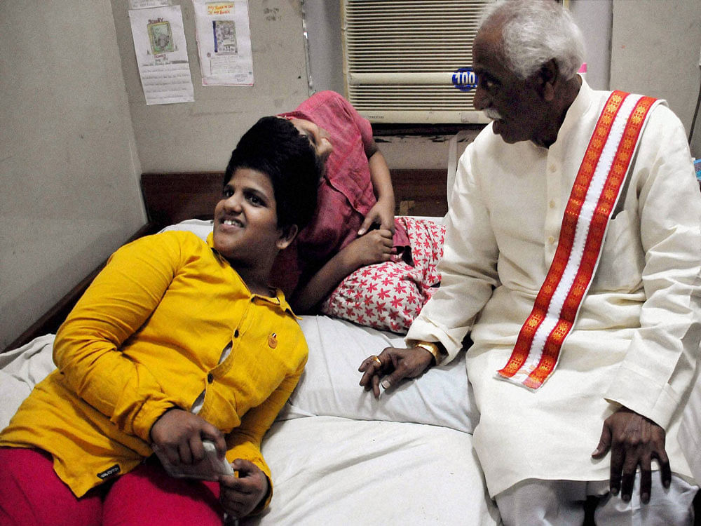 Bandaru Dattatreya, Union Minister for Labour & Employment interacting with conjoined twins 'Veena & Vani' at Niloufer Hospital in Red Hills in Hyderabad on Saturday. PTI photo
