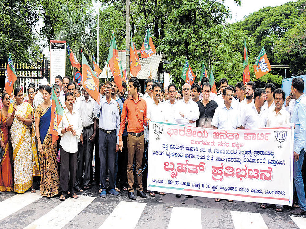 BJP members stage a protest demanding the authorities concerned to hand over the DySP M&#8200;K&#8200;Ganapathi suicide case to CBI and to arrest Minister K&#8200;J&#8200;George in Mangaluru on Saturday. DH photo