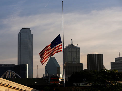 The U.S. flag flutters at half mast, two days after a lone gunman ambushed and killed five police officers at a protest decrying police shootings of black men, in Dallas, Texas, U.S., July 9, 2016. REUTERS