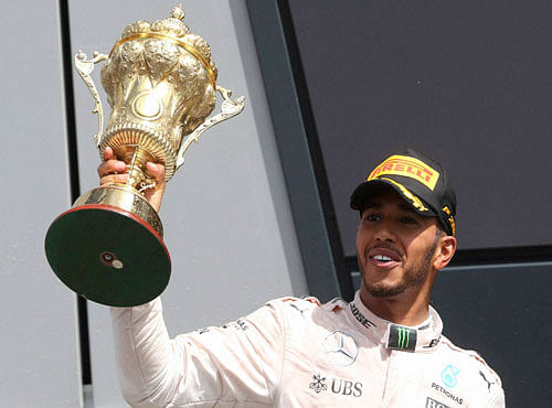 Mercedes driver Lewis Hamilton of Britain holds the trophy on the podium after winning the British Formula One Grand Prix at the Silverstone racetrack, Silverstone, England, Sunday, July 10, 2016.AP/PTI