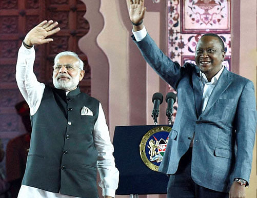 Prime Minister Narendra Modi and Kenyan President Uhuru Kenyatta waves as they arrive to address the Indian Community at Kasarni Stadium in Nairobi, Kenya on Sunday. PTI Photo
