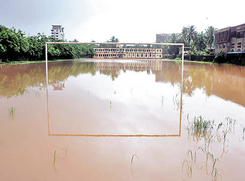 Rainwater floods the playground at the Bharathi English medium primary and high school in Ullal, Dakshina Kannada district. DH PHOTO