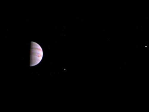The colour image shows atmospheric features on Jupiter, including the famous Great Red Spot, and three of the massive planet's four largest moons - Io, Europa and Ganymede, from left to right in the image. Photo credit: NASA