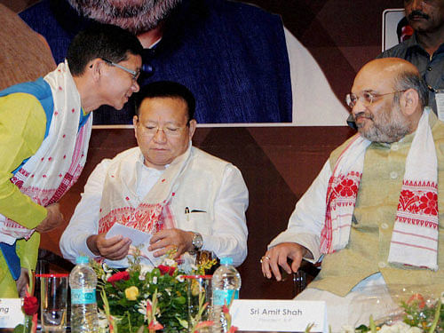 BJP national president Amit Shah talks to Arunachal Pradesh Chief Minister Kalikho Pul during the inaugural conclave of North East Democratic Alliance (NEDA) in Guwahati on Wednesday. Nagaland Chief Minister T R Zeliang is also seen. PTI Photo
