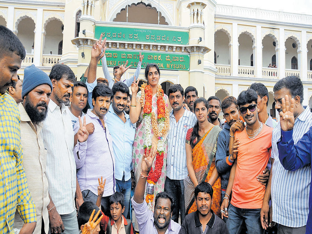 Newly elected corporator K&#8200;P&#8200;Ashwini celebrates her victory with supporters in front of Mysuru City Corporation  office in Mysuru on Wednesday. DH photo