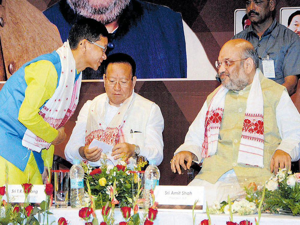 BJP national president Amit Shah talks to outgoing Arunachal Pradesh chief minister Kalikho Pul during the inaugural conclave of North East Democratic Alliance (NEDA) in Guwahati on Wednesday. Nagaland Chief Minister T R Zeliang is also seen. PTI