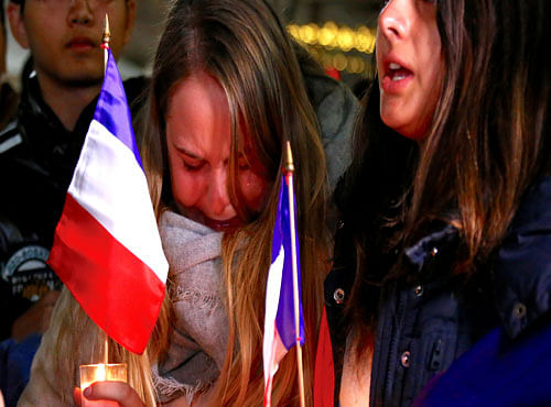 Members of the Australian French community cry as they sing the French national anthem during a vigil in central Sydney. Reuters photo