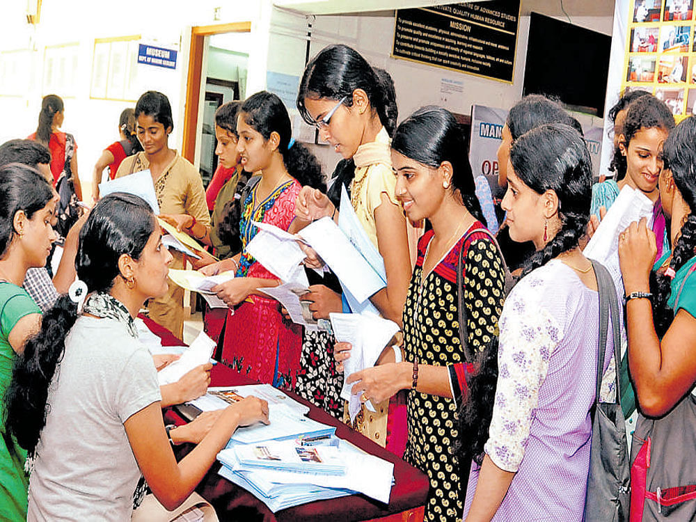 Students make enquiry in front of a department at 'Open House' at Mangalagangotri, the postgraduate&#8200;campus of Mangalore University, on Friday.