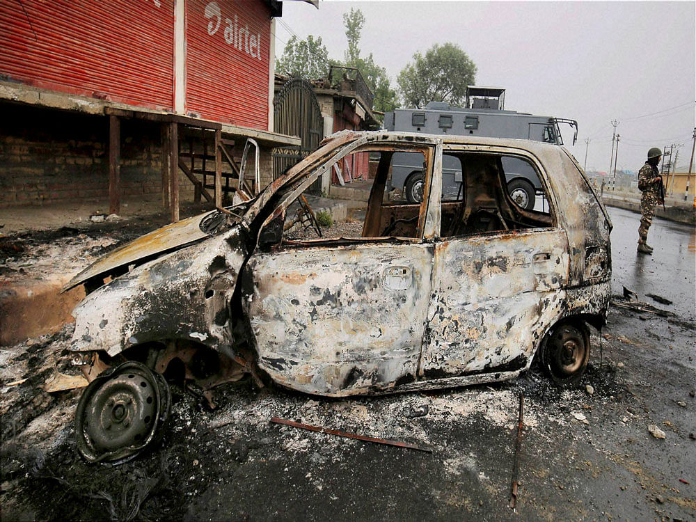 A vehicle which was set ablaze by Kashmiri protesters on the outskirts of Srinagar on Friday. PTI
