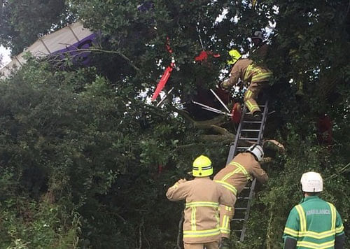 Fire crews eventually managed to free the pilot using ladders, lines and a winch, the BBC reported. Photo Credit: SECAmb Hart/Twitter