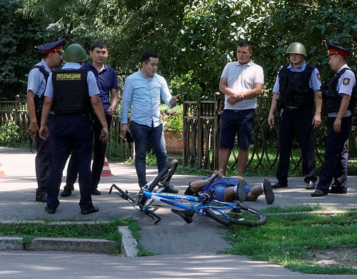Police officers detain a man after an attack in the centre of Almaty, Kazakhstan, July 18, 2016. REUTERS