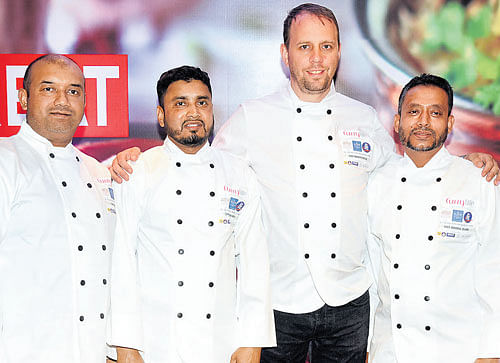 passionate Chef Mark Poynton (third from left) with his team. DH PHOTO BY B K JANARDHAN
