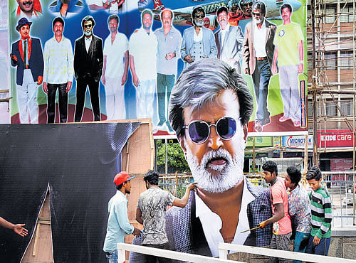 Rajinikanth fans put up cutouts and posters of his film 'Kabali' in front of Urvashi theatre in Bengaluru on Wednesday. DH PHOTO
