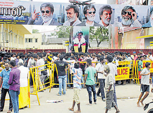 On the eve of the release of Kabali, Rajini fans wait outside a theatre in Chennai on Thursday. DH PHOTO
