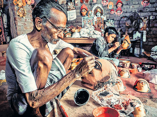 Creating new faces A family of mask makers at work in Purulia district of West Bengal; (below) 'chhau'  performers in their full gear.