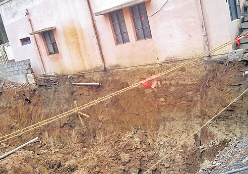 The foundation of a house is exposed due to soil excavation in Muniswamappa Layout.  dh photo
