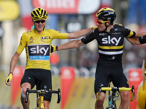 Yellow jersey leader Team Sky rider Chris Froome of Britain celebrates with team mates on the finish line. Reuters Photo.