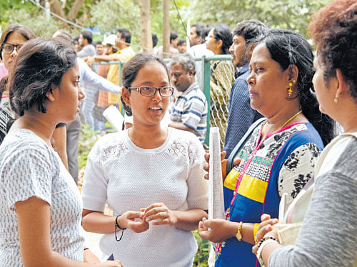 Students share their experience with their parents after writing The All India Pre Medical/ Pre Dental Medical test, National Eligibility Entrance Test (NEET)-II in Bengaluru on Sunday. DH Photo
