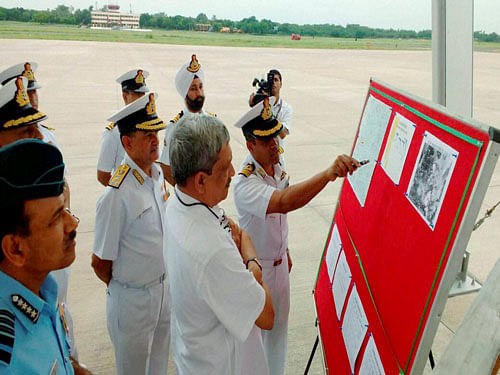 Defence Minister Manohar Parrikar being briefed on the search operations of missing IAF AN-32 aircraft at Naval Air Station, Arakkonam, Chennai. PTI Photo.