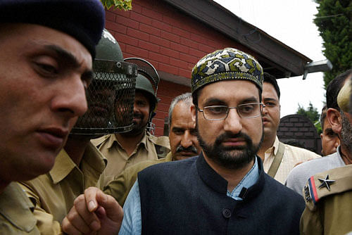 Police detain Chairman of the moderate faction of All Parties Hurriyat Conference Mirwaiz Molvi Umar Farooq outside his residence at Nigeen, to stop him from heading toward Anantnag to participate in a program to pay tribute to the people killed during the past 17 days of unrest in Kashmir, in Srinagar on Monday. PTI Photo