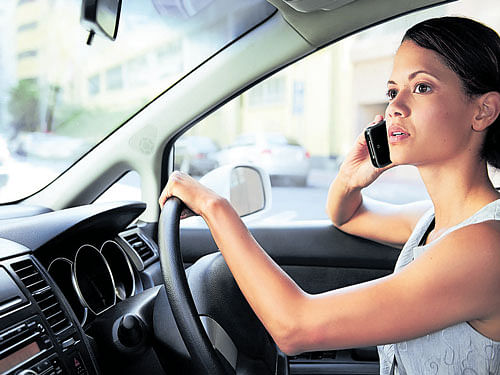 dangerous In spite of repeated warnings, people still tend to use mobile phones while driving.