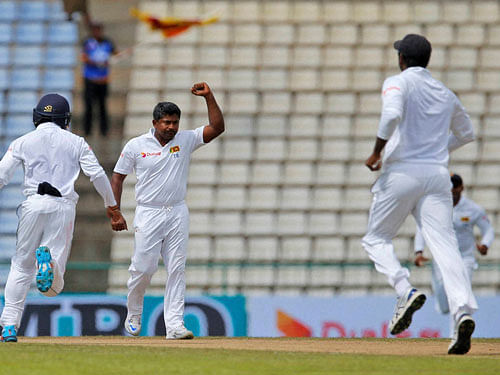 Sri Lankan bowler Rangana Herath, second right, and wicketkeeper Dinesh Chandimal, left, Kaushal Silva, second left, and Angelo Mathews, right, celebrate the dismissal of Australian captain Steve Smith during the second day of the first test cricket match between Sri Lanka and Australia in Pallekele, Sri Lanka, Wednesday. AP/PTI