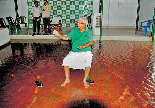 RJD Chief Lalu Prasad Yadav at his waterlogged residence after a press conference in Patna on Thursday. PTI Photo