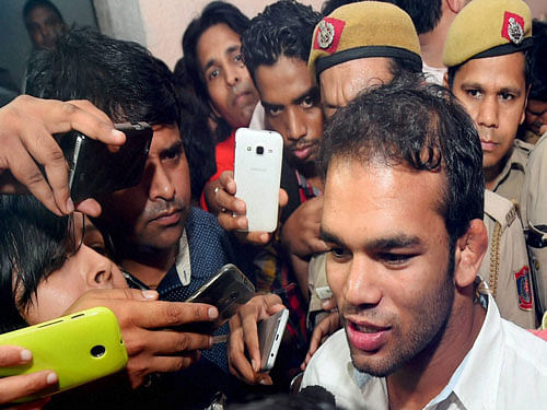 Wrestler Narsingh Yadav talks to the media as he comes out of the NADA office after a hearing on his dope scandal, in New Delhi on Thursday. PTI Photo