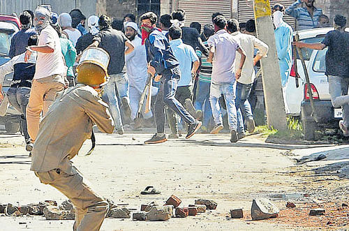 Police and protesters clash in Srinagar on Thursday. PTI