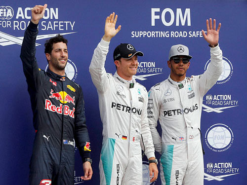 From left, Red Bull driver Daniel Ricciardo of Australia, Mercedes driver Nico Rosberg of Germany and Mercedes driver Lewis Hamilton of Britain pose after the Formula One qualifying in Hockenheim, Germany, Saturday. AP/ PTI