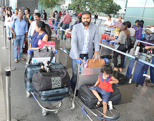 Passengers wait for taxis at the Kempegowda International Airport. DH Photos