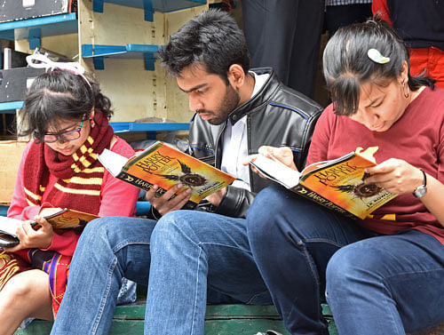 People busy in reading Harry Potter book after purchased on first day of release, at a book shop in Church Street, Bengaluru. DH Photo by S K Dinesh