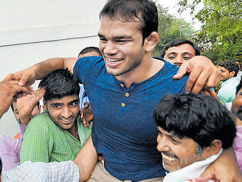 Supporters lift wrestler Narsingh Yadav in New Delhi on Monday. PTI
